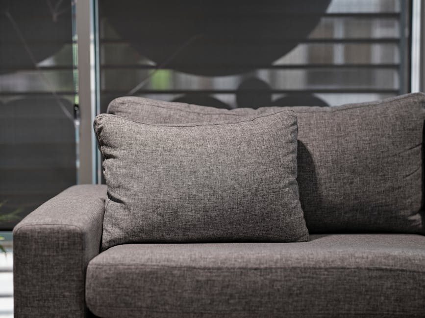 Detailed upholstery cleaning on a fabric sofa